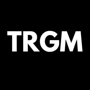 May include: The white capital letters TRGM are displayed prominently against a black backdrop. The font is a clean, sans-serif style. The image has a minimalist, graphic design.