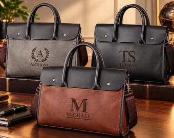 May include: Three rectangular briefcases with top handles and shoulder straps. One is grey with a laurel wreath and the name ANTHONY, one is black with the initials TS and THOMAS, and one is brown with the letter M and the name MICHAEL.