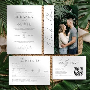 May include: A set of wedding stationery with a minimalist design. The invitation features the names "Miranda and Oliver" and wedding details. A photo of the couple is included. The RSVP card has a QR code. The stationery is on a background of tropical leaves.
