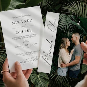 May include: Wedding invitation suite featuring a photo and invitation cards. The invitation card has the names "Miranda and Oliver" and wedding details. The photo shows a couple. The suite is held against a backdrop of green leaves.
