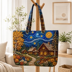 May include: A quilted tote bag featuring a vibrant landscape scene with a stone path leading to wooden cabins under a starry night sky. The design includes a large yellow moon, swirling blue clouds, golden trees, and colorful flowers.