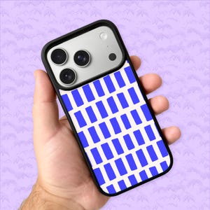 May include: A smartphone case with a black border and a white background featuring a pattern of blue rectangles. The phone case is held in a hand, showcasing the design. The phone has three camera lenses.