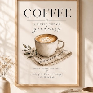 May include: A framed wall art print featuring a coffee cup on a napkin with the text COFFEE, A LITTLE CUP OF goodness, SIMPLE. WARM. ESSENTIAL., and made for slow mornings AND BUSY DAYS. The illustration includes a small leafy branch.