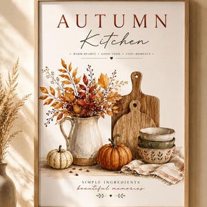 May include: A framed wall art print titled AUTUMN Kitchen with the text WARM HEARTS, GOOD FOOD, COZY MOMENTS and SIMPLE INGREDIENTS beautiful memories. It features a white pitcher with autumn leaves, two pumpkins, wooden boards, and bowls.