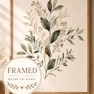 May include: A framed wall art print featuring a watercolour illustration of botanical branches with green leaves and small tan berries on a cream background. The wooden frame surrounds the artwork, which includes a circular badge reading FRAMED READY TO HANG.