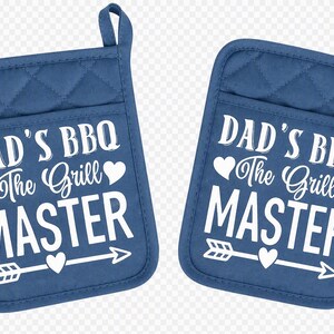 May include: Two blue quilted oven mitts featuring white text that reads DAD'S BBQ The Grill MASTER with heart icons and an arrow graphic. Each mitt includes a small fabric loop at the top corner for hanging, providing a matching set for kitchen use.