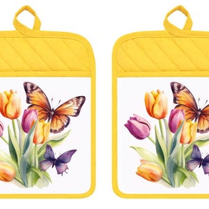 May include: A pair of rectangular pot holders with a bright yellow quilted border and a hanging loop. The center features a white background with a printed illustration of orange, yellow, and purple tulips accompanied by an orange and a purple butterfly.