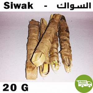 May include: Several brown Siwak sticks, wrapped in natural fibres. The image shows multiple pieces, with the text "Siwak" and "20 G" visible. The sticks are arranged on a light background.