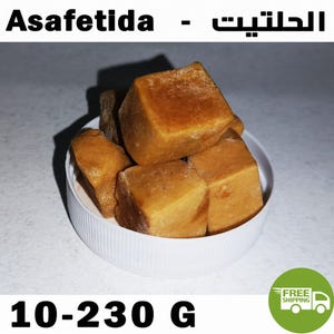 May include: Several amber-coloured, resinous cubes of Asafetida are piled inside a white circular plastic lid. The text Asafetida is printed at the top, and the text 10-230 G is printed at the bottom of the image, indicating the weight range.
