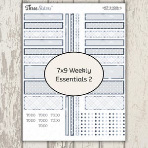 May include: A sticker sheet labeled Three Sisters MST-3-1006-A 7x9 Weekly Essentials 2 featuring various rectangular labels in shades of blue with patterns including clouds, dots, and plaid, plus small TO DO text and circular stickers.