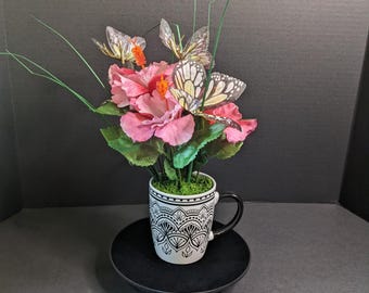 Butterfly‑Accented Pink Floral Arrangement in Decorative Patterned Mug