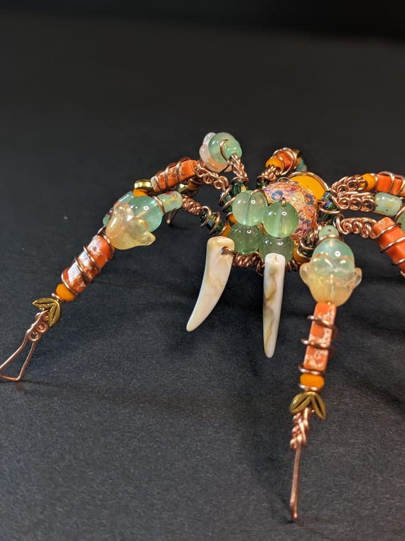 A handmade beaded copper wire spider sculpture — one-of-a-kind oddity art that looks like it escaped a steampunk cabinet of curiosities.