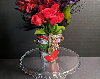 Face Vase with Purple and Red Floral Arrangement