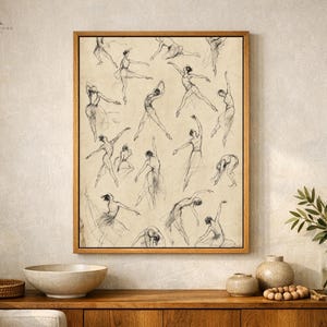 May include: A rectangular framed wall art piece featuring a collection of black charcoal sketches of ballet dancers in various poses on a beige background. The artwork is enclosed in a simple light brown wooden frame, showcasing multiple figures.