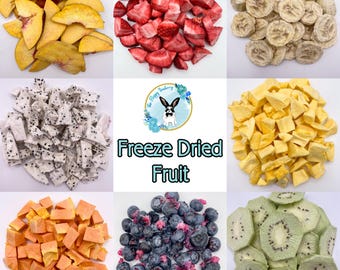 May include: A collection of freeze-dried fruit including sliced peaches, diced strawberries, banana chips, dragon fruit cubes, mango chunks, papaya pieces, blueberries, and kiwi slices. A central logo features a rabbit and the text Freeze Dried Fruit.