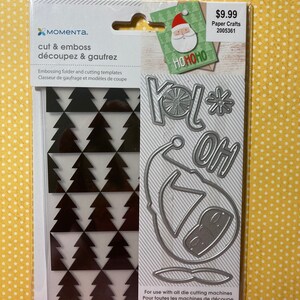 May include: A white card with black and white Christmas tree pattern on the left and a silver die cut with the words "Yol* Oh" on the right. The card is labeled "cut & emboss découpez & gaufrez" and "8 PC/PZ".