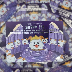 May include: A rectangular game card featuring a purple and white illustration of a central white creature with orange horns and a crown, surrounded by smaller similar creatures. The text reads TOKEN BATTLEFIELD BARON PIL (YOU CAN'T START THE GAME WITH A TOKEN BATTLEFIELD.) UNITS CAN MOVE HERE FROM ANYWHERE.