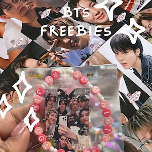 May include: A beaded bracelet featuring pink letter beads spelling out BTS member names, interspersed with small white round beads. The bracelet is packaged in a clear plastic sleeve containing a small group photograph of the band members.