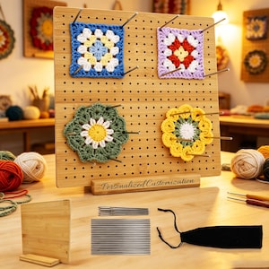 May include: A rectangular bamboo blocking board with a grid of holes, featuring the text Personalized Customization on the base. Four crocheted floral and square motifs are pinned to the board with metal rods. Includes a set of metal pins and a black pouch.