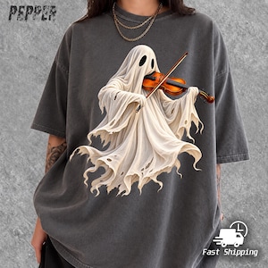 May include: A charcoal gray short-sleeve t-shirt featuring a graphic of a white ghost playing a brown wooden violin. The ghost has tattered edges and dark oval eyes. The word PEPPER is printed in the top left corner in a distressed black font.