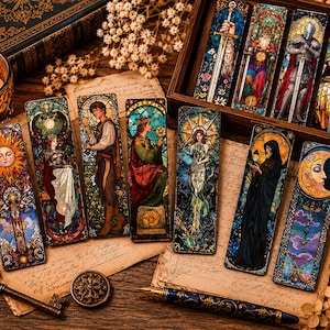 May include: A collection of stained-glass style bookmarks featuring medieval and fantasy themes. The bookmarks depict figures with swords, crowns, and celestial bodies. The color palette includes blues, reds, yellows, and greens. Some bookmarks are displayed in a wooden box.