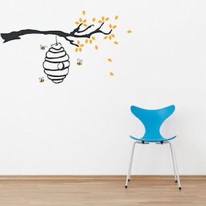 May include: A black and white silhouette of a tree branch with yellow leaves and a honeycomb hanging from it. There are small black and yellow bees flying around the honeycomb. A blue chair is in the foreground.