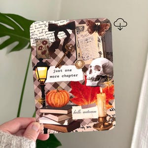 May include: A rectangular card featuring a collage of autumn-themed imagery including a stack of books, a pumpkin, a skull, a lit candle, a street lamp, a key, a moth, and a brown bow. The text reads "just one more chapter" and "hello autumn".