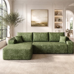May include: A large, L-shaped sectional sofa upholstered in a textured, olive green corduroy fabric. The sofa features a chaise lounge on the left side, three back cushions, and two small square throw pillows in the same matching green fabric.