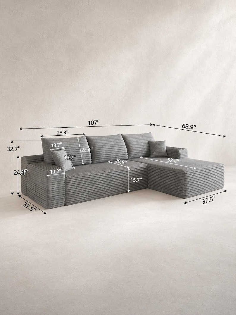 May include: A gray corduroy sectional sofa with a chaise lounge, featuring three back cushions and two small square throw pillows. The sofa measures 107 inches in total width, 68.9 inches in depth, and 32.7 inches in total height.