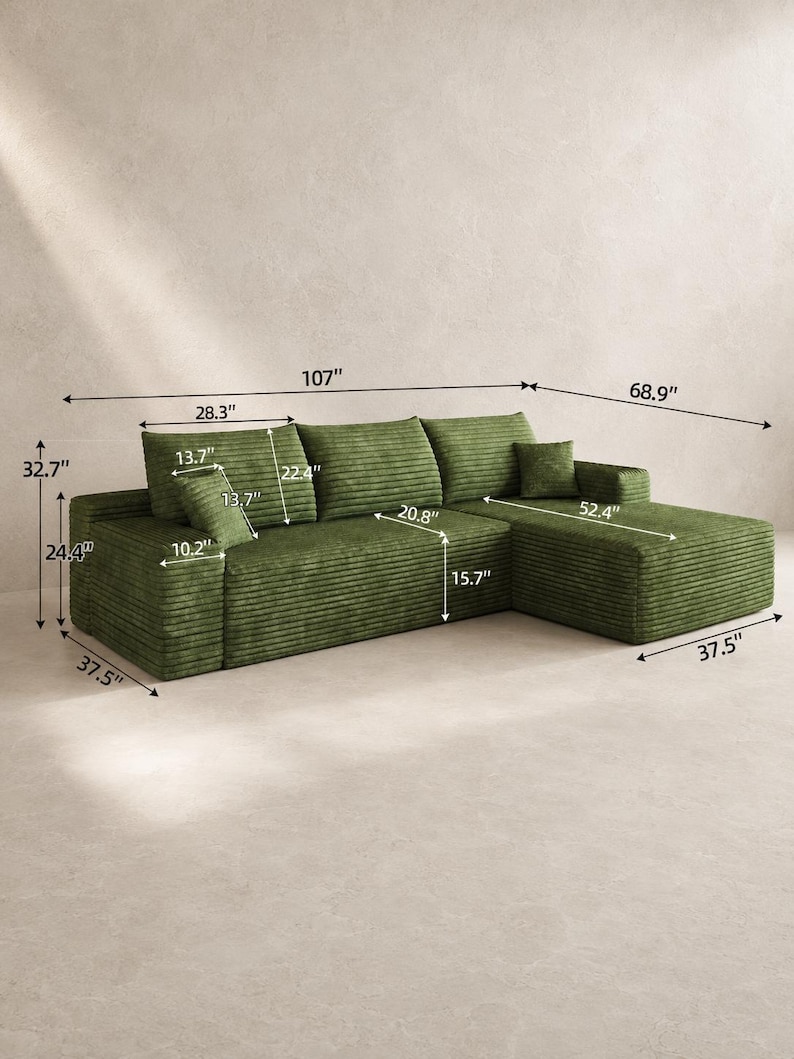 May include: A green corduroy sectional sofa with a chaise lounge, featuring three back cushions and two small square throw pillows. The sofa has a total width of 107 inches, a depth of 68.9 inches, a height of 32.7 inches, and a seat height of 15.7 inches.