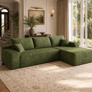 May include: A large, L-shaped sectional sofa upholstered in a textured, olive green corduroy fabric. The sofa features three wide back cushions, a chaise lounge section on the right side, and two small, square accent pillows in the same green fabric.