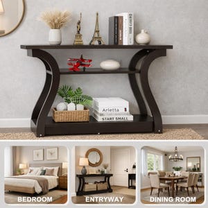 May include: A dark brown console table with curved side supports and two shelves. The top shelf holds a vase, two metal statues, books, and a white bowl. The middle shelf holds a red toy airplane, a white bowl, and a woven basket with plants.