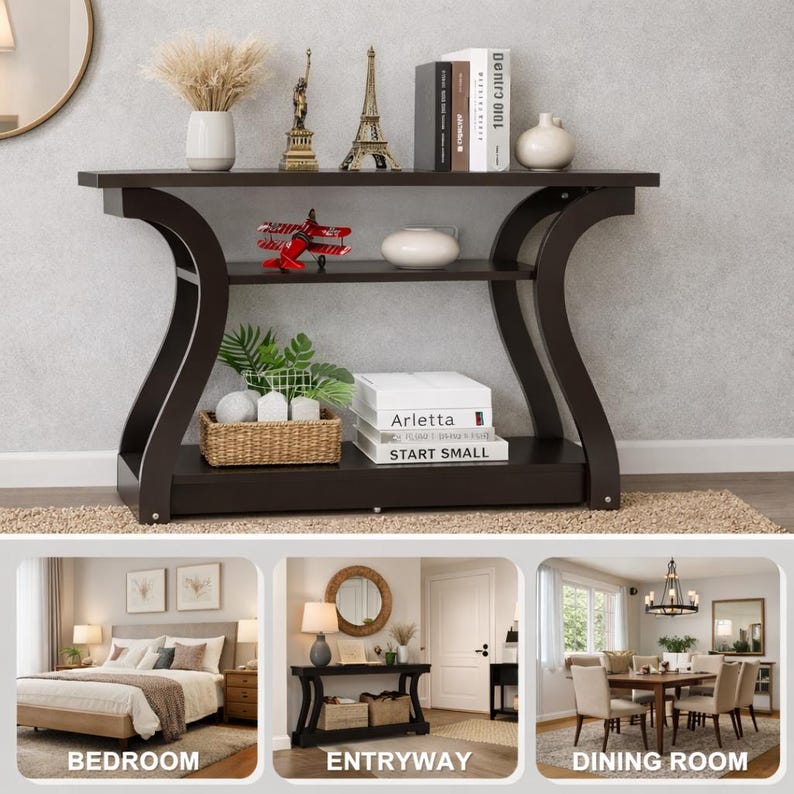 May include: A dark brown console table with curved side supports and two shelves. The top shelf holds a vase, two metal statues, books, and a white bowl. The middle shelf holds a red toy airplane, a white bowl, and a woven basket with plants.