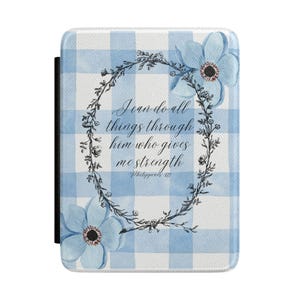 May include: A light blue and white gingham pattern case with a floral wreath and two blue flowers. The text "I can do all things through him who gives me strength" is inside the wreath.