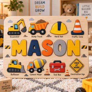 May include: A wooden name puzzle featuring the name MASON in large, colorful letters. The board includes cutouts for an excavator, dump truck, hard hat, traffic cone, bulldozer, cement mixer, tool box, and a yellow diamond-shaped construction sign.