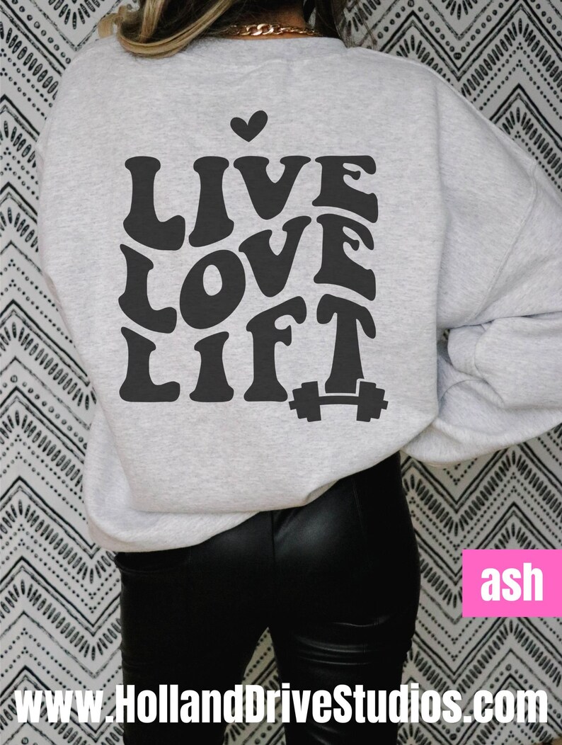 May include: A grey sweatshirt with the text "LIVE LOVE LIFT" in a retro font with a small heart above the word "LIVE" and a dumbbell icon below the word "LIFT".