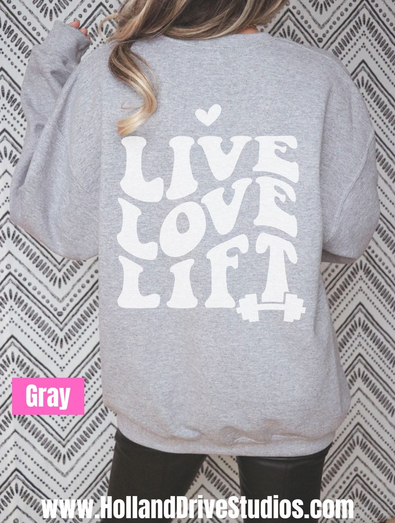 May include: Grey sweatshirt with the text "LIVE LOVE LIFT" in white with a small heart above the text and a white dumbbell below the text.