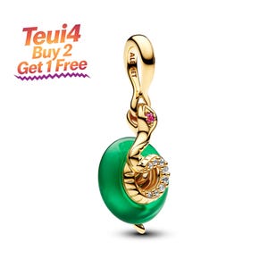 May include: A gold-toned metal charm featuring a coiled snake design with a small pink stone for an eye and clear pavé crystals along its body. The snake is wrapped around a smooth, circular green bead. The bail is engraved with ALE MET.
