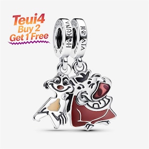 May include: A silver charm featuring two dangling figures, a meerkat and a warthog, with enamel details in brown, tan, and red. The bail is engraved with the text PANDORA, S925, HAKUNA, and MATATA. Text in the upper left corner reads Teui4 Buy 2 Get 1 Free.