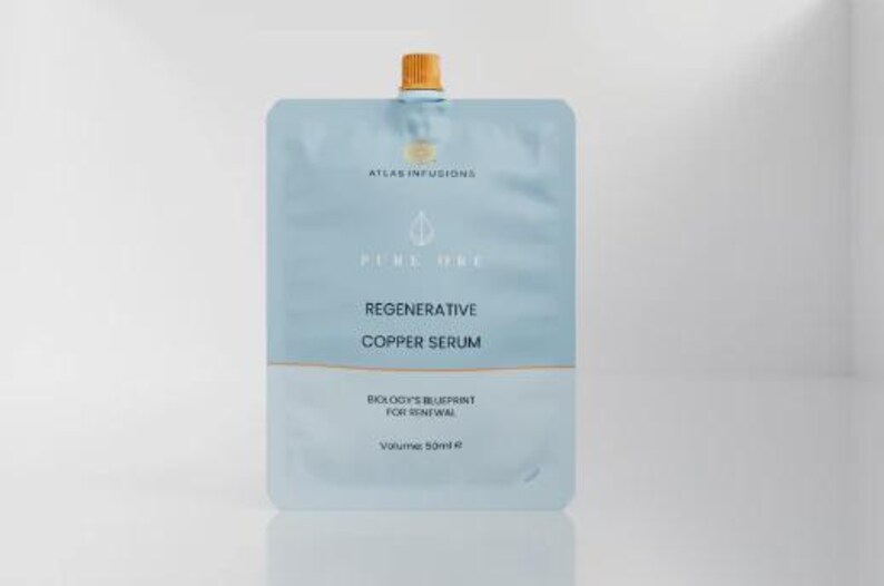 May include: A light blue and white packet of Regenerative Copper Serum. The packet has the text "ATLAS INFUSIONS", "PURE ONE", and "BIOLOGY'S BLUEPRINT FOR RENEWAL". The volume is 50ml.