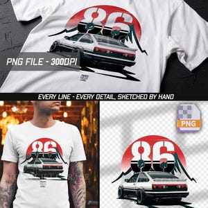 Op de afbeelding: Een wit t-shirt met korte mouwen en een grafische print van een wit-zwarte sportwagen van achteren gezien. Het ontwerp bevat een grote rode cirkel, zwarte bergsilhouetten en het getal 86 in vetgedrukte witte letters met zwarte strepen.