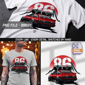 May include: A white t-shirt featuring a graphic print of a red sports car viewed from the rear, positioned in front of a large red circle and black mountain silhouettes. The number 86 is displayed in large white font above the car.
