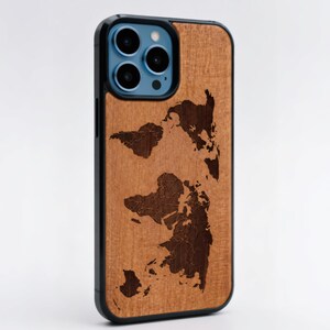May include: A wooden phone case with a black border. The case features a detailed map design etched into the wood. The phone case is a warm brown color and has the text "CORIUMLAB" at the bottom.
