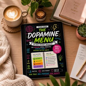 May include: A digital tablet displaying the cover of a workbook titled The Dopamine Menu: An ADHD-Friendly Workbook. The black cover features colorful text, icons, and a graphic showing a menu for energy levels, with a pink circle stating 100+ pages.