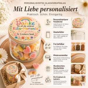 May include: A clear glass storage jar with a wooden lid featuring a colorful rainbow, floral illustrations, and the German text Danke f&uuml;r all die sch&ouml;nen Kita-Momente. The jar is filled with assorted gummy candies and shown in a gift box.