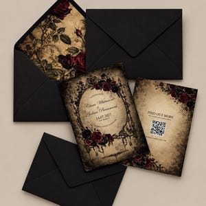 May include: A set of black envelopes and two rectangular cards with a vintage aesthetic. The cards feature dark red roses, ornate black frames, and text including Clara Whitmore & Julian Beaumont, 14.07.2027, and a QR code with the text FIND OUT MORE.