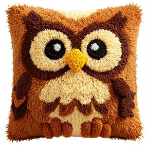 May include: A square throw pillow featuring a textured, shaggy yarn design of an owl. The owl has large black eyes with white highlights, a bright yellow beak, and a body composed of layered brown, tan, and cream-colored tufted yarn fibers.