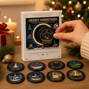 May include: A white rectangular music player display featuring the text Merry Christmas and a circular slot. A round black disc labeled Silent Night is being inserted. Eight additional round discs with various Christmas scenes are arranged below.