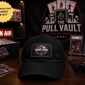 May include: A black baseball cap featuring a rectangular patch on the front. The patch displays a graphic with a basketball, football, and baseball, along with the text "YOUR LOGO" in white and red, and "SPORTS RELAY EST. 2024" below it.