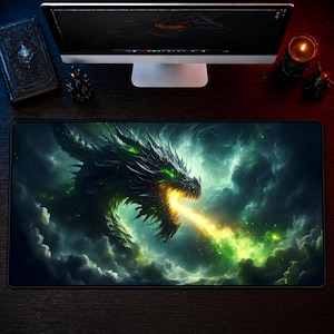May include: A rectangular desk mat featuring a dark, detailed illustration of a dragon emerging from swirling clouds. The dragon has sharp features, glowing green eyes, and is exhaling a bright yellow and green flame into the surrounding mist.